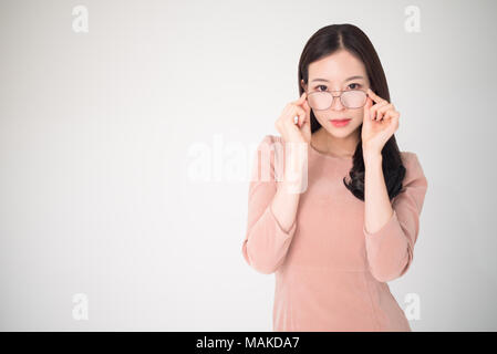 Eye problems concept such as near-sighted, myopia, far-sighted, astigmatism, cataract, glaucoma, ophthalmology, optometry. Asian woman holding eyeglas Stock Photo