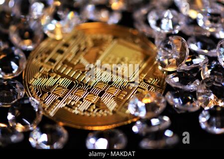 Bit coins with silver dollars and diamonds. Stock Photo
