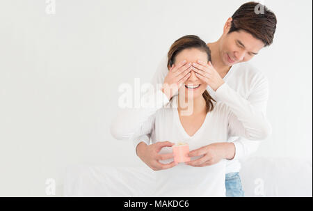 Asian lover or love couple wedding proposal concept, Asian man is surprising his girlfriend by proposing wedding ring gift box on white background, Ro Stock Photo