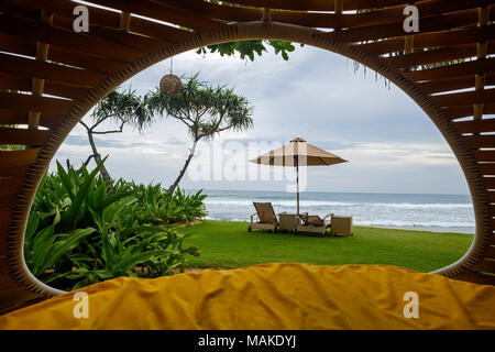 Cozy place inside cocoon hammock. View on tropical indian ocean. Stock Photo