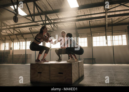 woman jumping box. Fitness woman doing box jump workout at cross fit gym  Stock Photo - Alamy