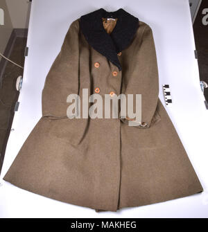 World War I olive drab wool army overcoat. Long coat features a black collar and a 'US' stamp inside the back on the lining. The coat was produced by A. B. Kirschbaum on a government contract during World War I. However, enlisted men were not issued overcoats as part of their uniform. It is possible that Alfred Rennekamp picked up this coat after the war as Army surplus for personal use. Title: World War I Army Issue Overcoat of Alfred H. Rennekamp  . 1918. A. B. Kirschbaum Co. Stock Photo