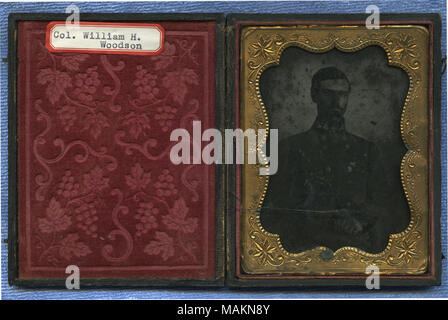 Cased ambrotype of a man with a beard shown holding a sword with his hands in front of him. He is wearing a double-breasted uniform coat with dark collar and pointed cuffs. Rank insignia is not clearly visible. A card with the image identifies Woodson as a colonel and states that he was from Liberty, Missouri and served on Gen. Price ?s staff. Service records on Missouri State Archives website state that Lt. Col. William H. Woodson was on Rains ? staff and Clark ?s staff. Woodson did in fact serve on Maj. Gen. Sterling Price ?s staff as Lieutenant Colonel under Brigadier Generals James S. Rain Stock Photo