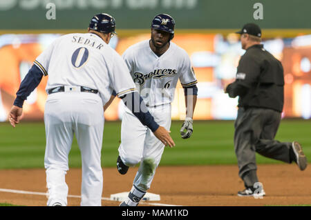 Milwaukee, WI, USA. 2nd Apr, 2018. Milwaukee Brewers center fielder Lorenzo Cain #6 is congratulated by Milwaukee Brewers third base coach Ed Sedar #0 after hitting a solo home run in the third inning of the Major League Baseball game between the Milwaukee Brewers and the St. Louis Cardinals at Miller Park in Milwaukee, WI. Cardinals defeated the Brewers 8-4. John Fisher/CSM/Alamy Live News Stock Photo