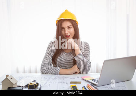 Architect or planner working on drawings for construction plans at a table Stock Photo