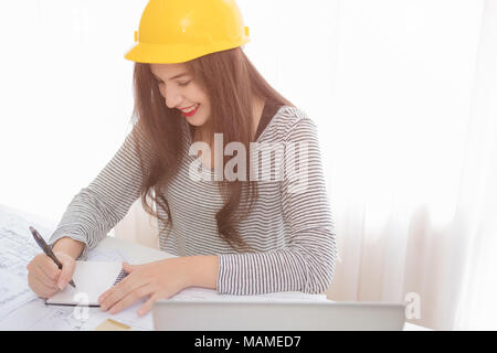 Architect or planner working on drawings for construction plans at a table Stock Photo