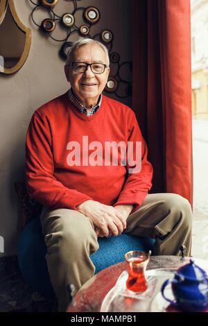 Portrait of happy senior man in a cafe. Stock Photo