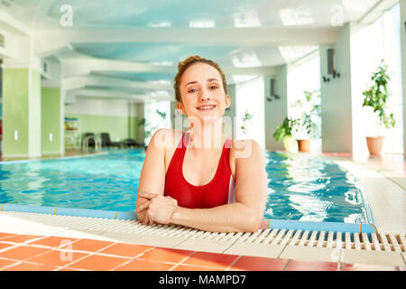 Cheerful Woman Posing in Pool Stock Photo