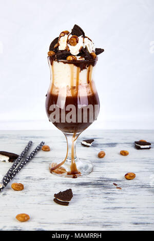 Extreme milkshake with chocolate, cookies and sweets. Crazy freakshake. Copy space. Food trend. Overshake Stock Photo
