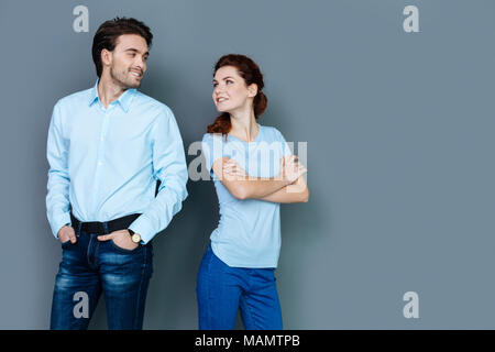 Positive happy people standing against grey background Stock Photo