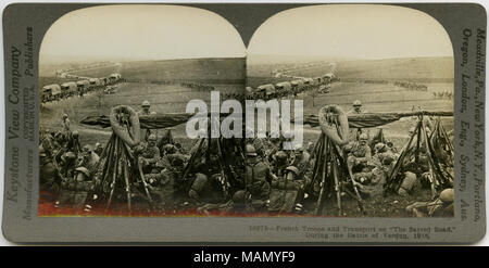 Horizontal, sepia stereocard showing French troops in uniform resting in a field. A road filled with caravans of supplies and uniformed men can be seen in the background. Keystone Stereograph number 18678. The title reads: 'French Troops and Transport on 'The Sacred Road,' During the Battle of Verdun, 1916.' Title: 'French Troops Resting After a Combat with 'Fritz' '  . 1916. Keystone View Company Stock Photo