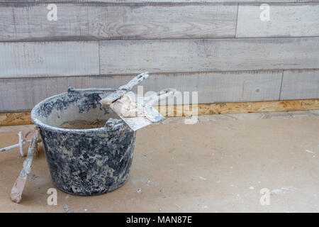 Construction tools on concrete background. Copy space for text. Set of assorted plaster trowel tools and spatula . Top view Stock Photo