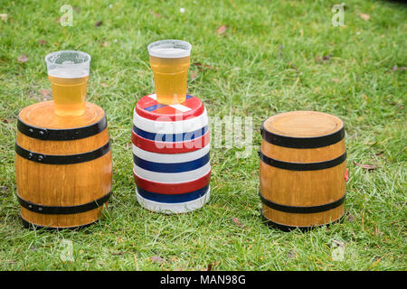 The three bottles (small kegs, two of beer, one empty), unadorned, and on the ground before the start of the annual easter monday contest with the nea Stock Photo