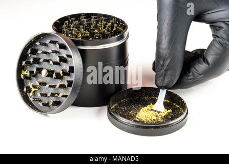 A medicinal marijuana grinder with keef and scraper. Black background ...
