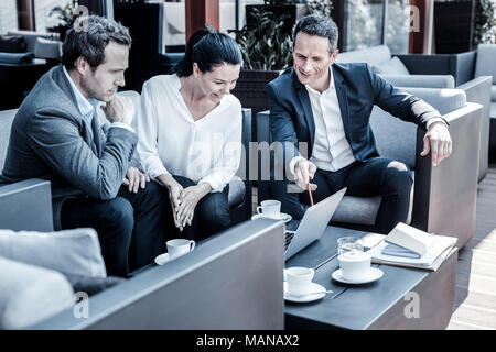Positive joyful businesspeople discussing new ideas Stock Photo