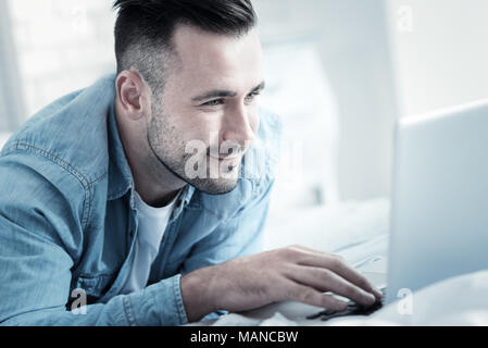 Joyful bearded man pressing the button Stock Photo