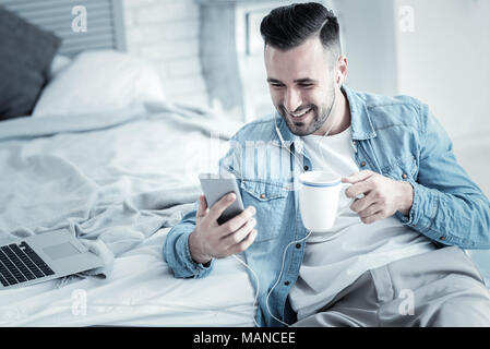 Positive joyful man having tea Stock Photo