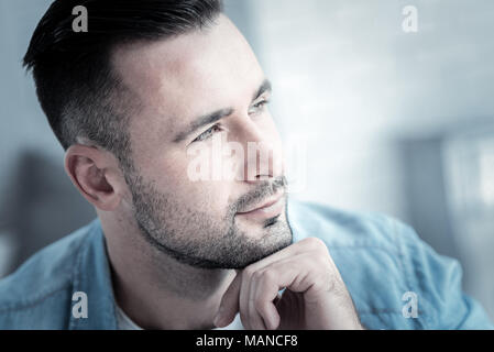 Nice thoughtful man holding his chin Stock Photo