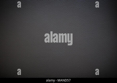 Surface of dark gray faux leather with vignette for textured background Stock Photo
