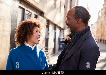 Middle Aged Couple Walking Through City In Fall Together Stock Photo