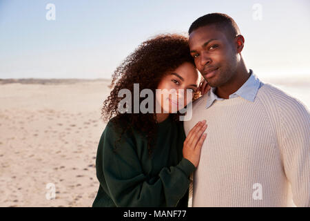 Portrait Of Couple On Walking Along Winter Beach Together Stock Photo