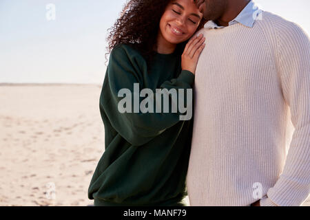 Close Up Of Couple On Walking Along Winter Beach Together Stock Photo