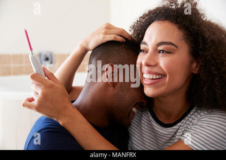 Couple Celebrating Positive Home Pregnancy Test Result Stock Photo