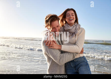 Couple Having Fun On Winter Beach Together Stock Photo