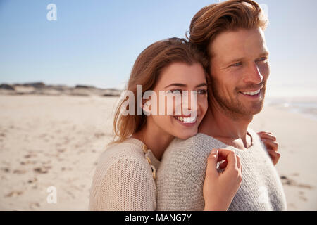 Romantic Couple Embracing On Winter Beach Stock Photo