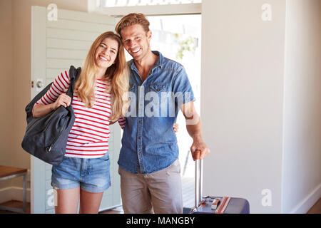 Portrait Of Couple Arriving At Summer Vacation Rental Stock Photo