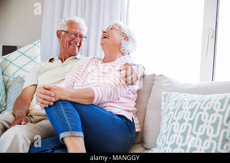 Senior Couple Relaxing On Sofa At Home Together Stock Photo