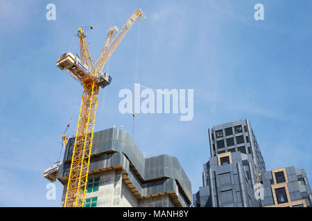 LONDON - MAY, 2017: Crane and modern buildings under construction against blue sky, in the City Of London Stock Photo