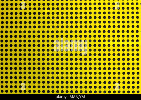 Yellow hole metal texture over a black background (selective focus, photographed with shallow DOF) Stock Photo