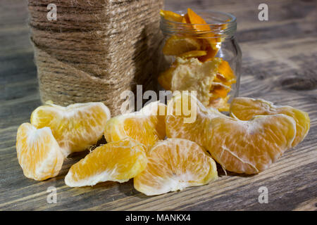 Mandarin slices on wooden background Stock Photo