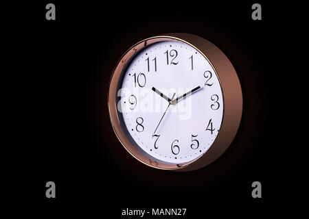 Close up of a Large Decorative ticking wall clock in metallic rose gold color and white face, accurate time as it is fitted with a quartz, Isolated ob Stock Photo