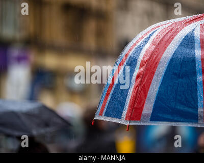 London Umbrellas in the Rain - Union Jack umbrella on Oxford Street in central London Stock Photo