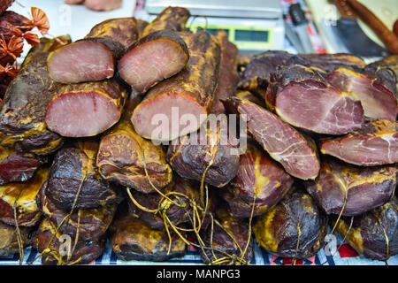 Various products from dried meat exposed to view and tasting before sale. Stock Photo