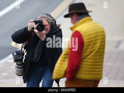 A Press Photographer photographing a man leaving Brighton Magistrates Court. Stock Photo