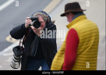 A Press Photographer photographing a man leaving Brighton Magistrates Court. Stock Photo