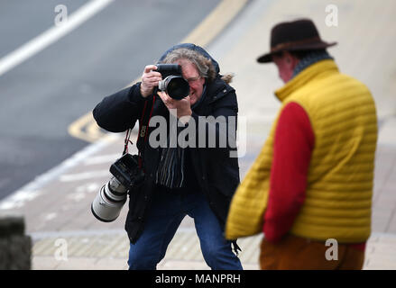 A Press Photographer photographing a man leaving Brighton Magistrates Court. Stock Photo