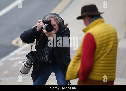 A Press Photographer photographing a man leaving Brighton Magistrates Court. Stock Photo