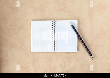 open notebook and graphic pencil isolated on paper background Stock Photo