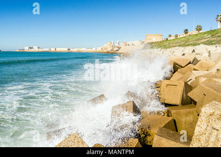 Atlantic waves breaking on the urbanized shore of old Cadiz, Andalusia, Spain