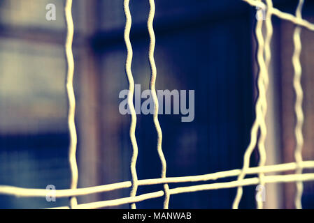 Fence with hole, wire fence, jail break scene. Stock Photo
