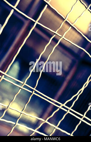 Fence with hole, wire fence, jail break scene. Stock Photo