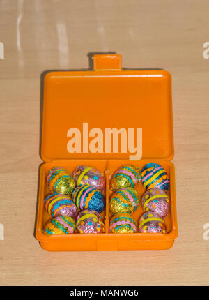 foil wrapped mini chocolate easter eggs in box Stock Photo