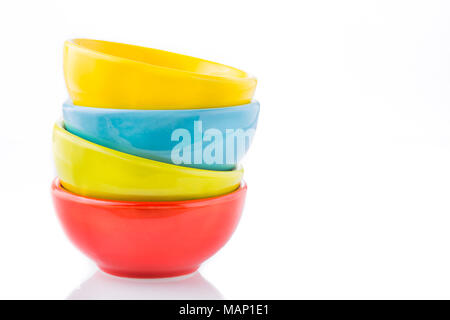 Ceramic rates of assorted colors stacked on white background Stock Photo