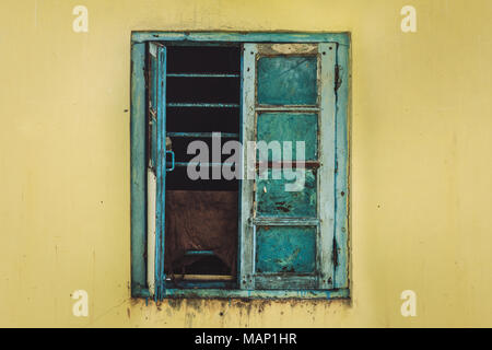 Open Old Window On yellow Wall. window with metal grating Stock Photo
