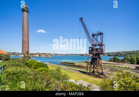shipyard crane at the slipway of Cockatoo Island shipyard heritage site against the backdrop of the powerhouse smoke stake, Sydney Harbour, New South  Stock Photo