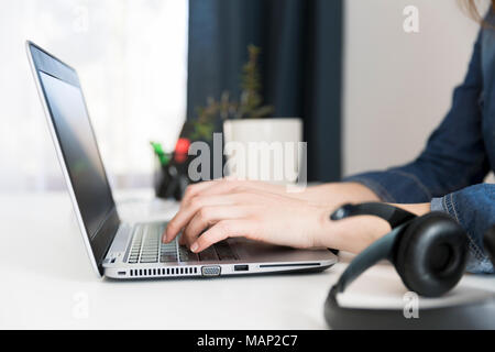 Customer service representative working on laptop at desk in office Stock Photo